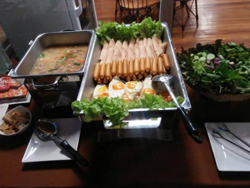 a table with a bunch of food on a table at Laekhon Nonbai in Nakhon Si Thammarat