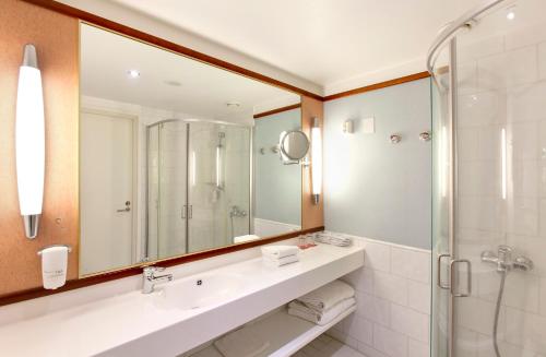 a bathroom with a sink and a shower at Holiday Club Tampereen Kehräämö in Tampere