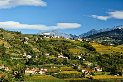 a village on a hill in the mountains at Hotel MARIA THERESIA adults-only in Lagundo