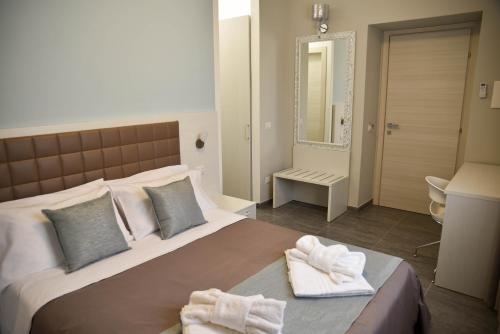 a bedroom with a large bed with towels on it at DolceLina Home in Lampedusa