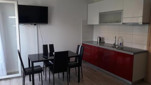 a kitchen with a black table and chairs and a sink at Villa Veronika in Omiš