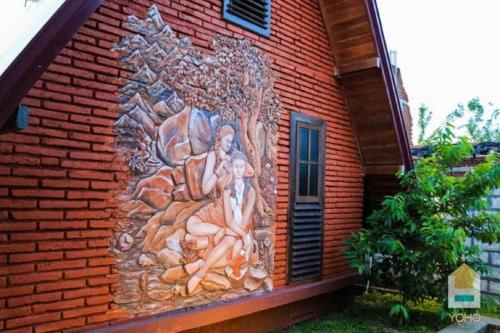 a mural on the side of a brick building at D Family Resort in Anuradhapura
