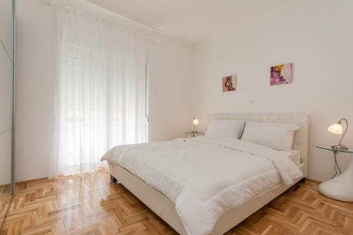 Postel nebo postele na pokoji v ubytování Apartments Kukuriku