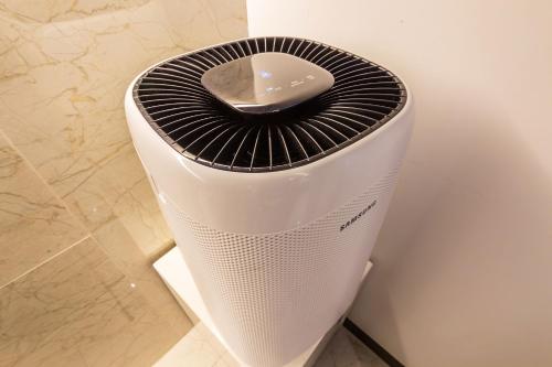 a white and black heater sitting on the floor at Guwol Hotel in Incheon