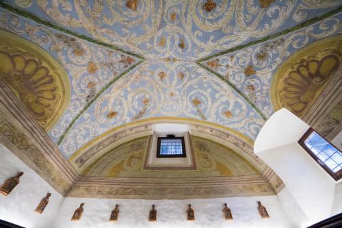 an ornate ceiling in a building with a window at Convento San Bernardino in Montefranco