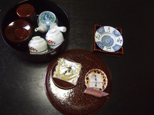 a table topped with a plate and a bowl with a plate at Tashiro Annex in Yakushima