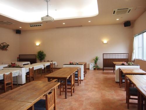 a dining room with wooden tables and chairs at Tashiro Annex in Yakushima