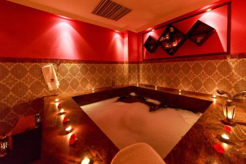 a bathroom with a tub with lights in it at Islamabad Serena Hotel in Islamabad