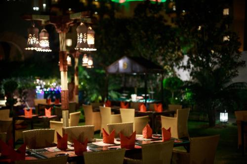 a group of tables and chairs with red paper boats on them at Islamabad Serena Hotel in Islamabad