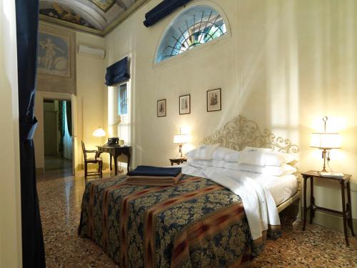 a bedroom with a bed and a table and a window at Antica Casa Zucchini B&B in Bologna