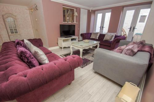 a living room with two couches and a tv at Little Paris - Parking - by Brighton Holiday Lets in Brighton & Hove