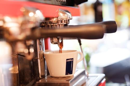 a coffee maker is making a cup of coffee at Bel and The Dragon-Odiham in Odiham