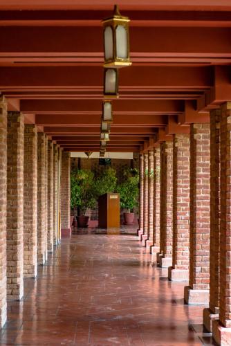 a hallway of a building with columns and plants at Faisalabad Serena Hotel in Faisalabad