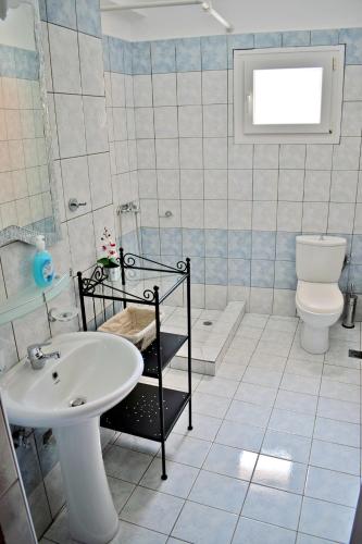 a bathroom with a sink and a toilet at Villa Eva in Skala Rachoniou