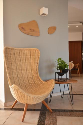a rattan chair and a table in a room at Enorme Maya Beach Hotel-Adults Only in Gouves