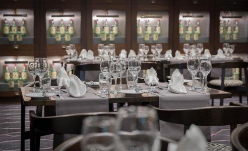 a set of tables with wine glasses and napkins at Talbot Hotel Wexford in Wexford