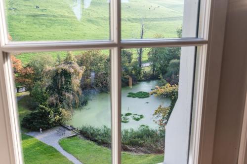 a window view of a pond from a house at Schloss Wartensee in Rorschacherberg