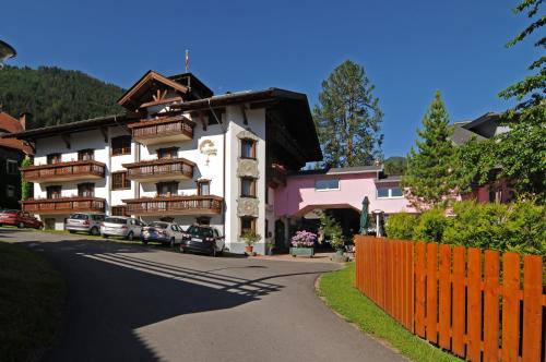 a building on a street with a orange fence at Erholungshotel Margarethenbad in Rangersdorf