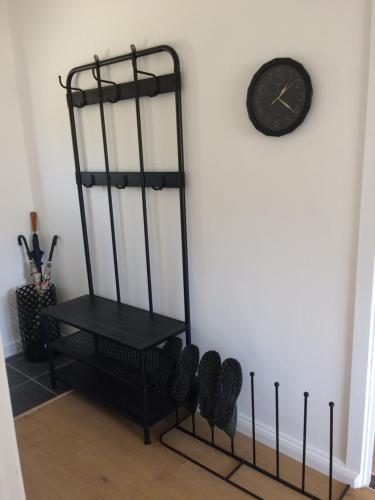a black shelf next to a clock on a wall at Annie's River Retreat in Doochary