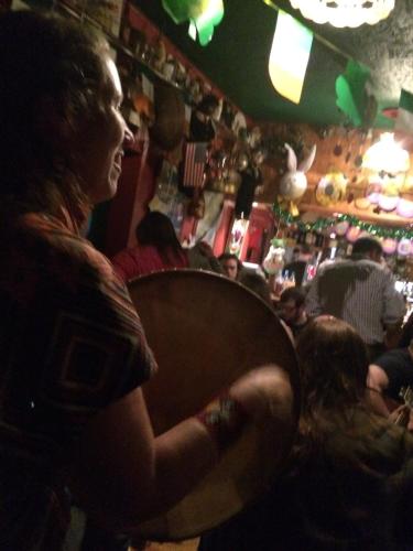 a woman sitting in a crowd of people in a bar at Annie's River Retreat in Doochary