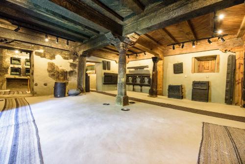 a large room with aamed ceilings and a large room with columns at Serena Shigar Fort in Shigar