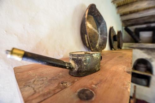 a metal measuring cup sitting on top of a wooden table at Serena Shigar Fort in Shigar