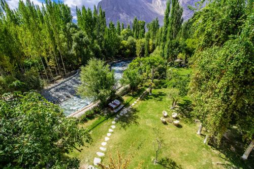 an aerial view of a river in a forest at Serena Shigar Fort in Shigar