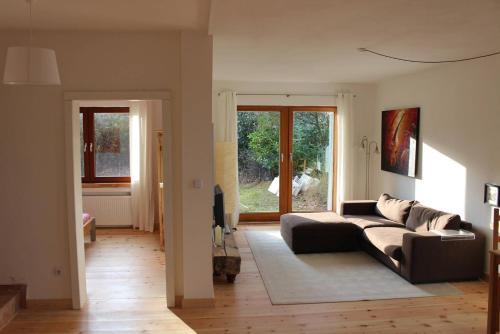 a living room with a couch and a window at Top Appartement 2 in Rosengarten/Hamburg in Rosengarten