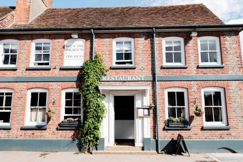 a red brick building with a white door at Bel and The Dragon-Kingsclere in Kingsclere