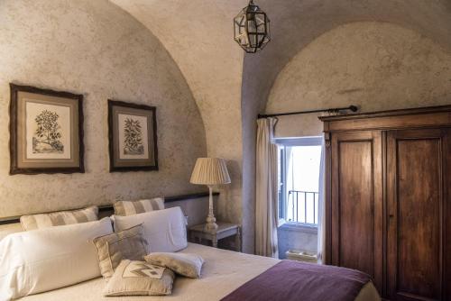 a bedroom with a large bed and a window at Relais Del Maro in Borgomaro