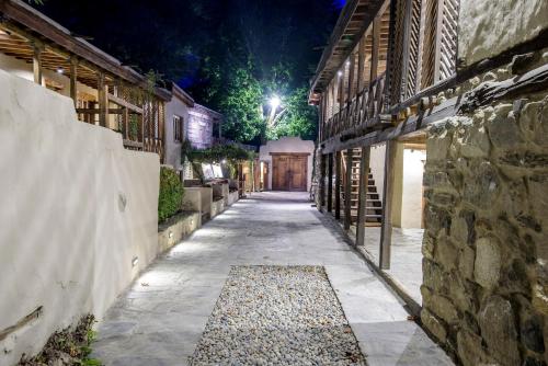an empty alley at night with a stone wall at Serena Shigar Fort in Shigar