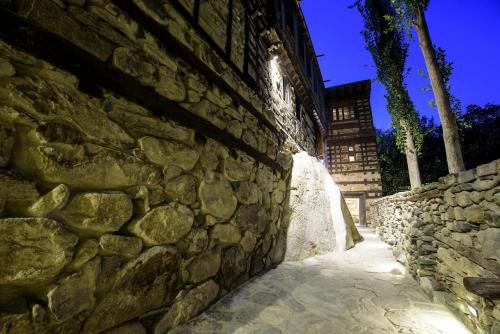 a stone wall next to a stone path at Serena Shigar Fort in Shigar