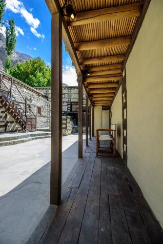 a wooden porch with awning on a building at Serena Shigar Fort in Shigar