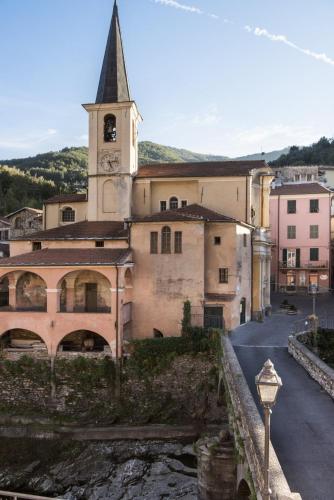 a building with a church with a clock tower at Relais Del Maro in Borgomaro