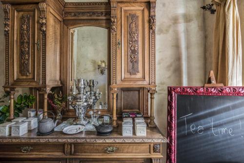 a wooden dresser with a mirror and a chalkboard at Relais Del Maro in Borgomaro
