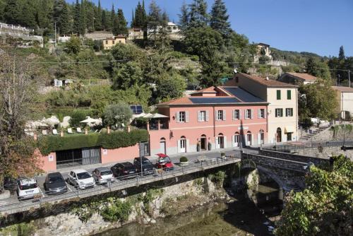 a bridge over a river next to a building at Relais Del Maro in Borgomaro