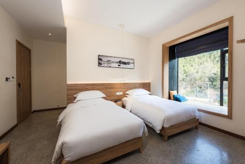 Tempat tidur dalam kamar di Yunshan Villa