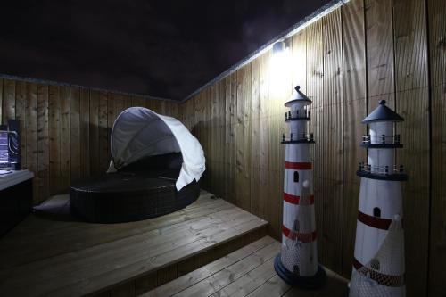 a wooden room with a hat and a lighthouse at Guwol Hotel in Incheon