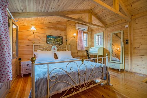 a bedroom with a bed in a wooden room at Akrathos Houses in Polychrono