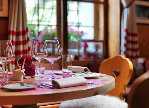 a table with wine glasses and napkins on it at Giardino Mountain in St. Moritz