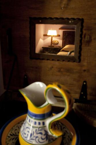 a vase sitting on a table in front of a mirror at El Requexu, apartamentos a 900 m de la playa de Poo AR-0474-AS in Llanes