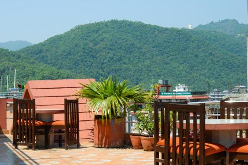a balcony with chairs and a view of a mountain at Hotel Admire Pokhara Pvt. Ltd. in Pokhara