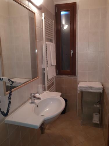 a bathroom with a sink and a mirror at Residence Buca di Bacco in Volta Mantovana