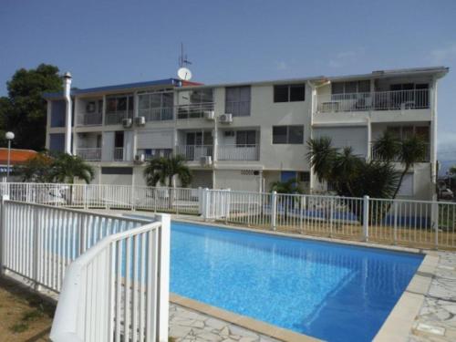 a large building with a swimming pool in front of a building at CoCoKreyol "Antigua" in Les Trois-Îlets