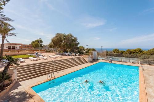 a swimming pool with people in the water at Sun Club El Dorado - All Inclusive in Llucmajor