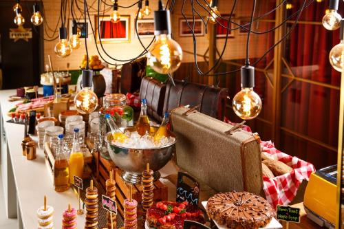 a table with food on it with lights and bulbs at ibis Styles London Southwark - near Borough Market in London