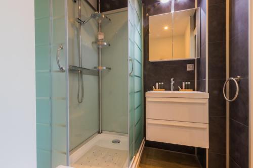 bagno con doccia e lavandino di ORION B&B a Ledegem