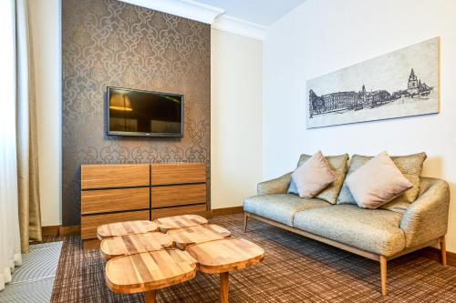 a living room with a couch and a coffee table at Radisson Blu Hotel, Kyiv Podil City Centre in Kyiv