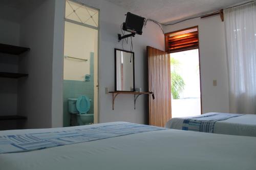 Ένα ή περισσότερα κρεβάτια σε δωμάτιο στο Hotel Carruiz
