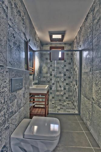 a bathroom with a toilet and a sink and a shower at Vintage Villas in Kuşadası